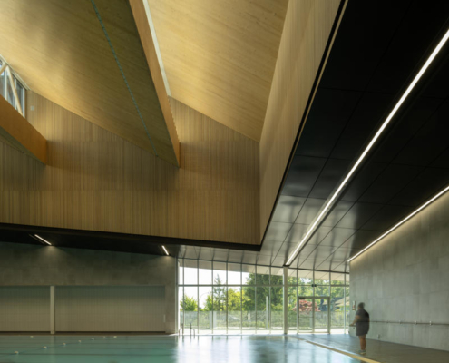 7-hcma_t╔Öm╔Ösew╠ôtx╩ÀACC_50m Lap pool with Mass Timber Sawtooth clerestory above_Credit Nic Lehoux